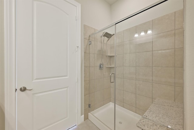 bathroom with a shower with shower door