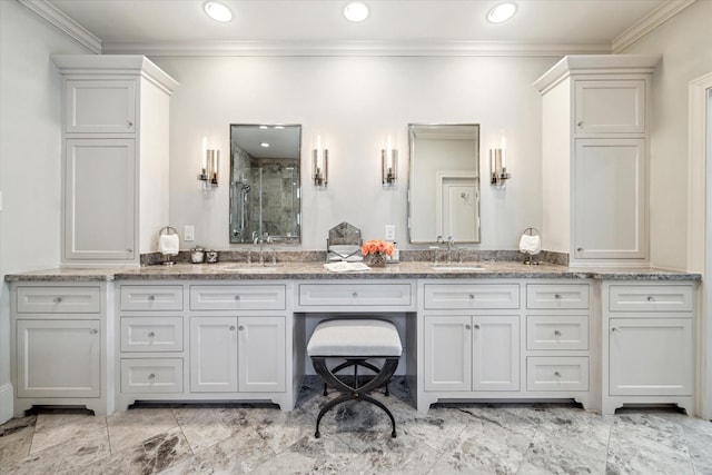 bathroom featuring a shower with door, vanity, and ornamental molding