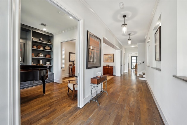 corridor with crown molding, dark wood-type flooring, and built in features