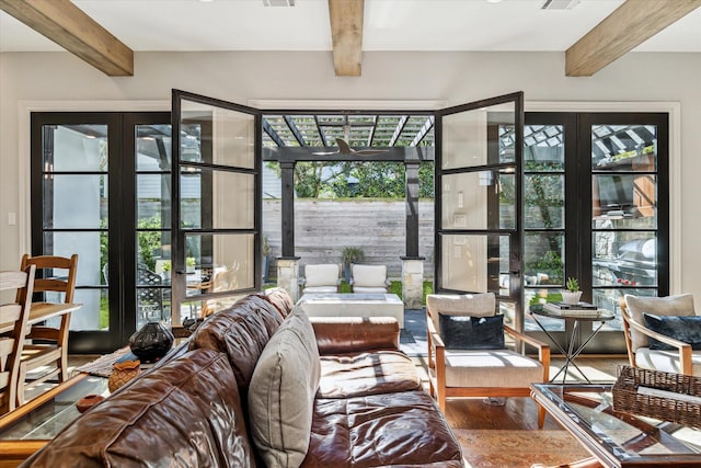 living room featuring hardwood / wood-style floors, beam ceiling, and french doors