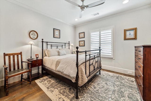 bedroom with crown molding, dark hardwood / wood-style floors, and ceiling fan