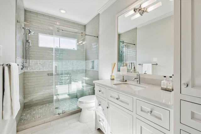 bathroom featuring crown molding, vanity, toilet, and an enclosed shower