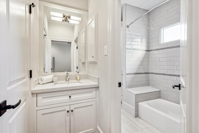 bathroom featuring vanity and tiled shower / bath