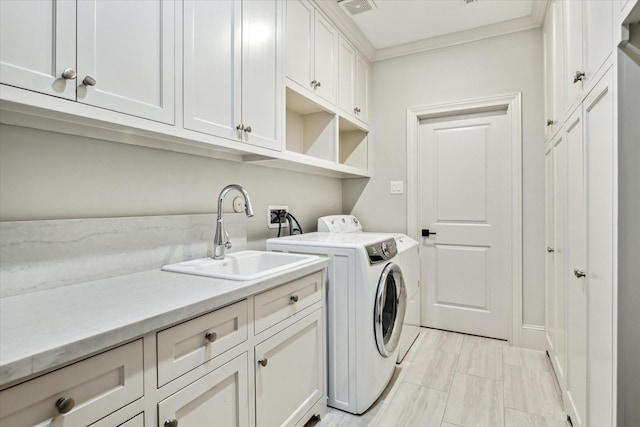 washroom with independent washer and dryer, cabinets, ornamental molding, and sink