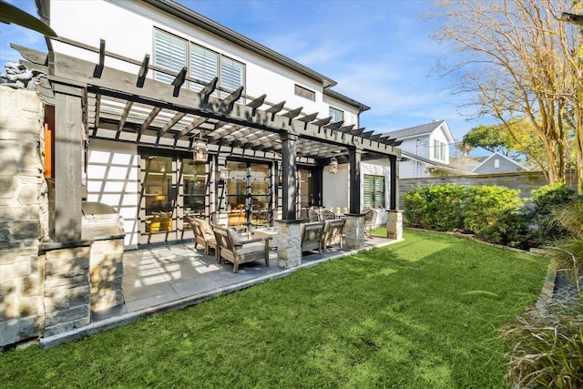 rear view of property featuring a yard, a pergola, and a patio