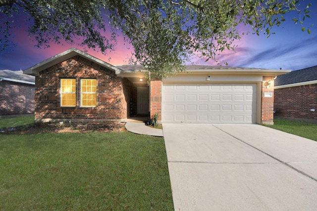 ranch-style home with a garage and a lawn