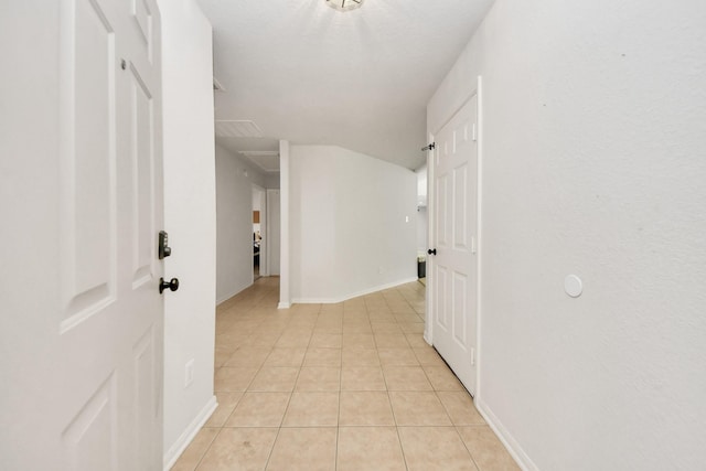 corridor featuring light tile patterned floors