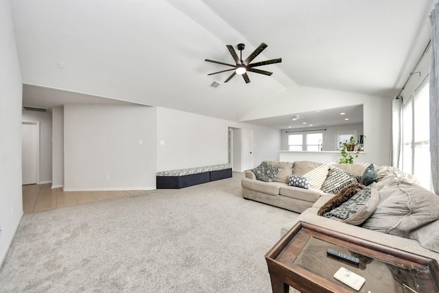 living room with carpet floors, ceiling fan, and vaulted ceiling