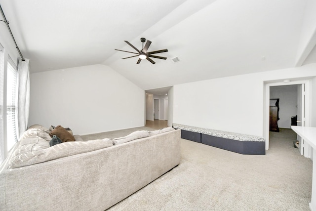 living room featuring ceiling fan, lofted ceiling, and carpet