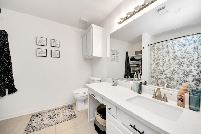 bathroom featuring vanity, tile patterned flooring, and toilet