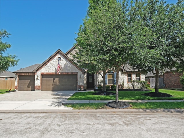 view of front of property with a garage and a front yard