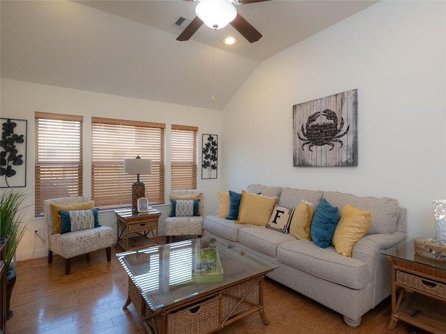 living room with hardwood / wood-style flooring, vaulted ceiling, and ceiling fan