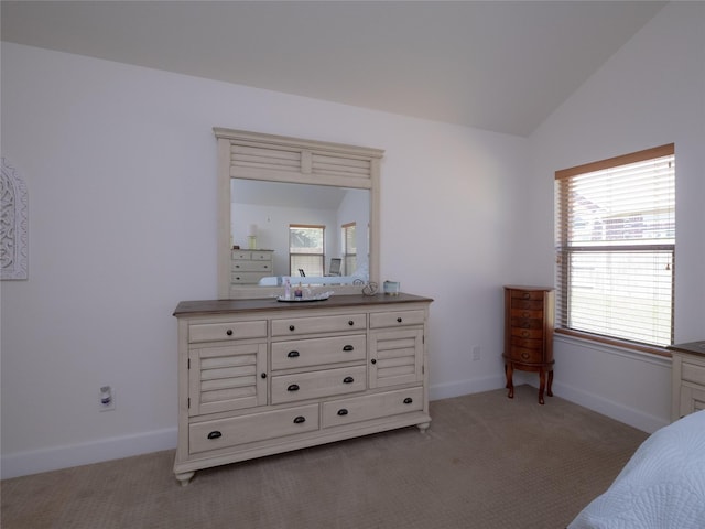 bedroom featuring vaulted ceiling and light colored carpet