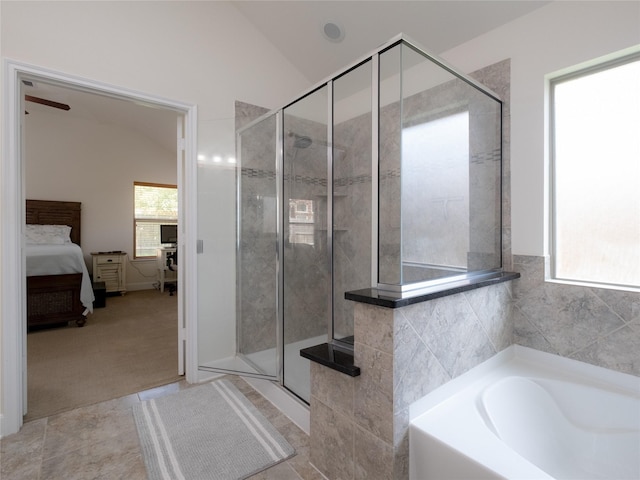 bathroom featuring tile patterned flooring, lofted ceiling, and separate shower and tub