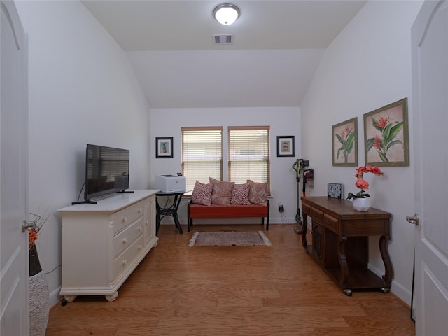 sitting room featuring light hardwood / wood-style floors and vaulted ceiling