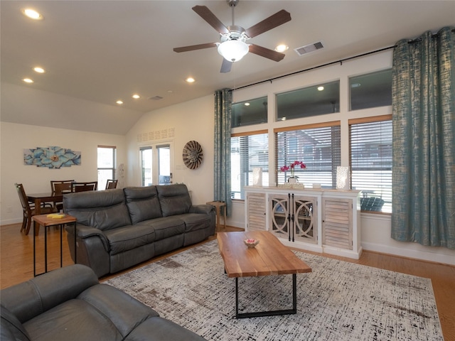 living room featuring vaulted ceiling, ceiling fan, and light hardwood / wood-style floors