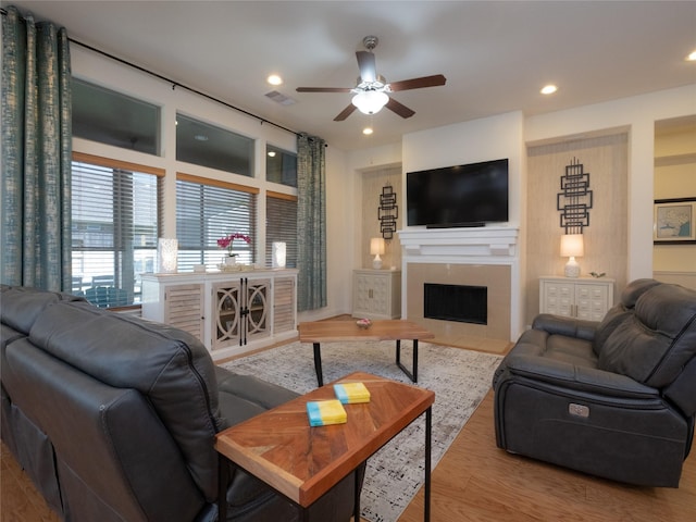 living room featuring hardwood / wood-style flooring and ceiling fan