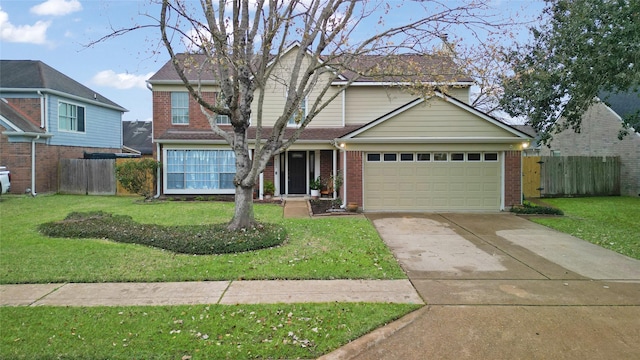 traditional-style house with brick siding, concrete driveway, a front yard, and fence