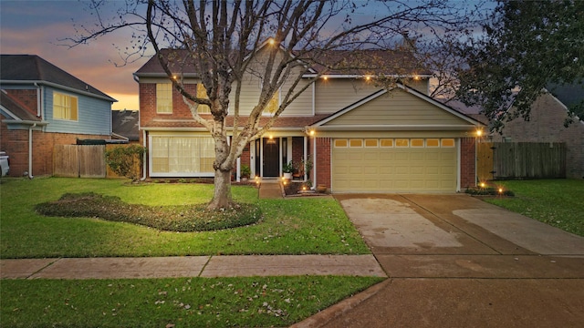 view of front facade featuring a garage and a lawn