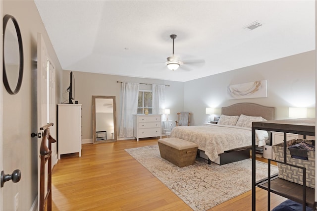 bedroom with ceiling fan and wood-type flooring