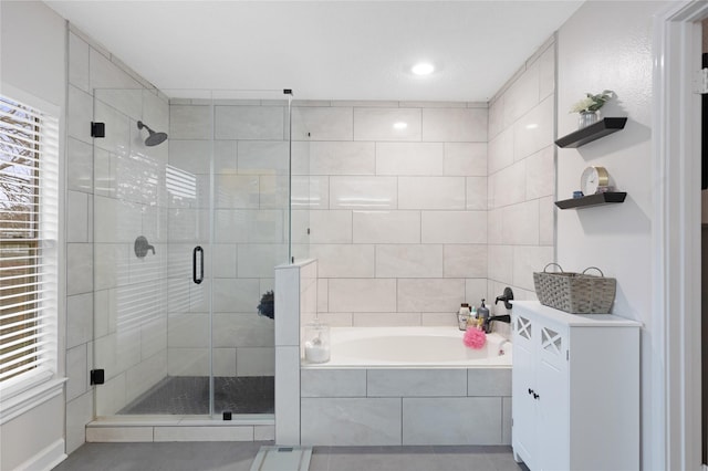 bathroom featuring tile patterned flooring, shower with separate bathtub, and plenty of natural light