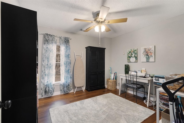 office area featuring ceiling fan, dark hardwood / wood-style floors, and a textured ceiling