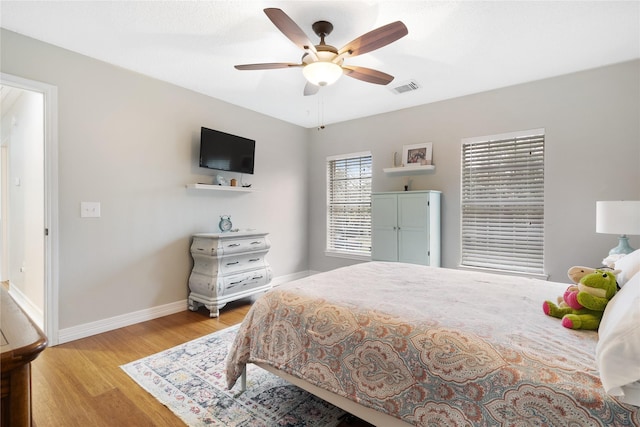 bedroom with ceiling fan and light hardwood / wood-style floors