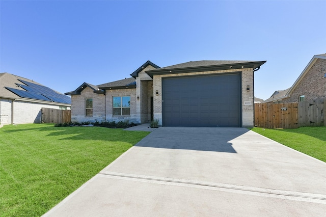 single story home featuring a garage and a front lawn