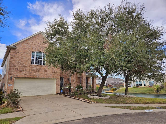 view of front facade featuring a water view and a garage