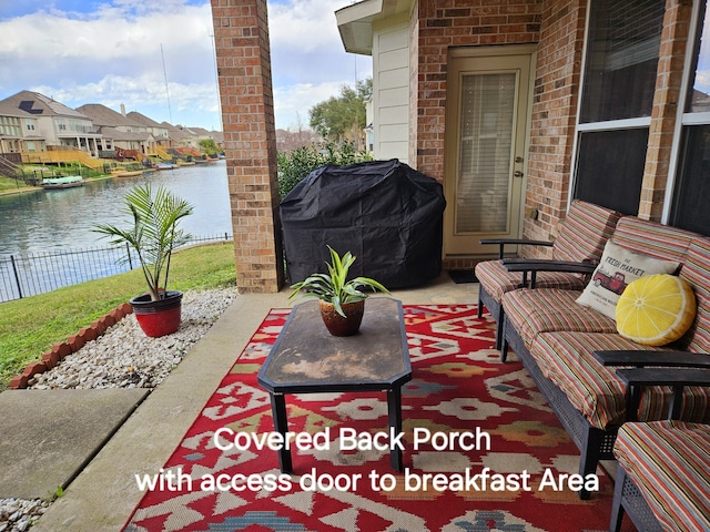 view of patio / terrace with a water view and area for grilling