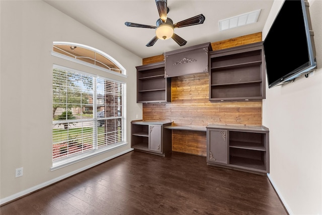 unfurnished office featuring ceiling fan and dark hardwood / wood-style floors