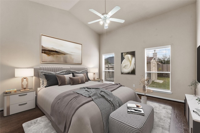 bedroom with ceiling fan, dark hardwood / wood-style flooring, and high vaulted ceiling