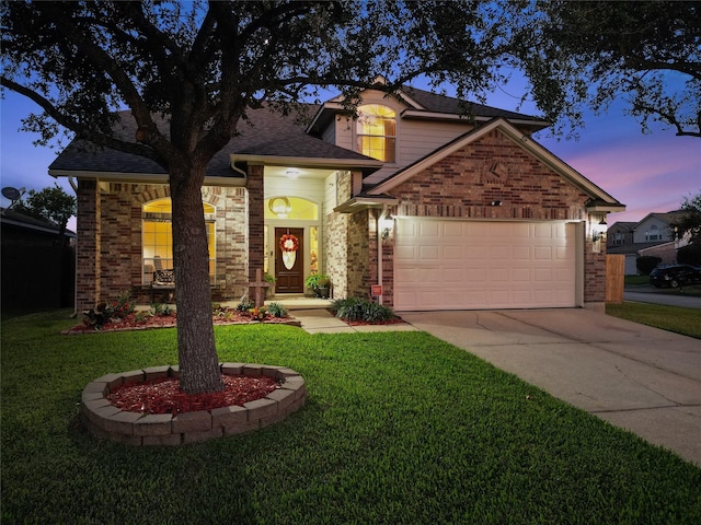 view of front facade with a garage and a yard