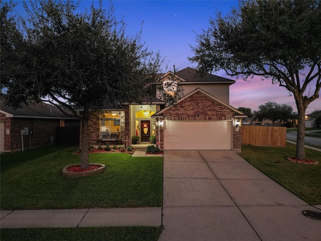 view of front of home with a garage and a yard