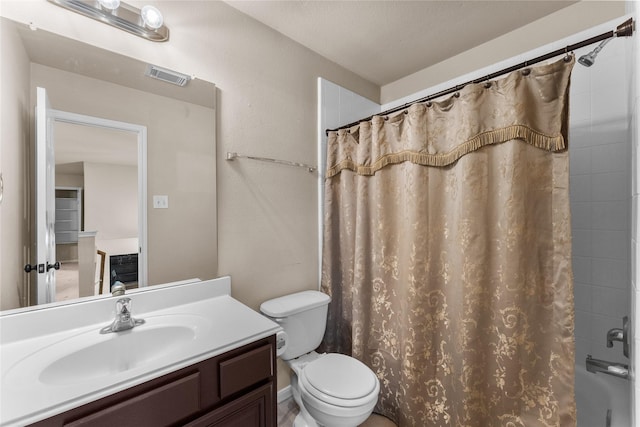 full bathroom with vanity, toilet, and shower / tub combo with curtain