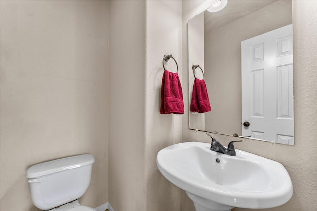 bathroom featuring sink and toilet