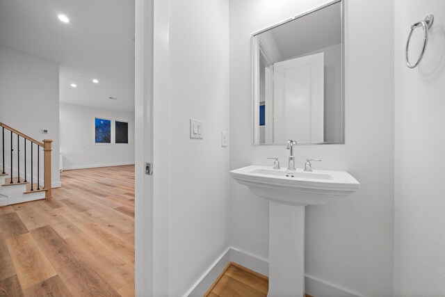 bathroom with hardwood / wood-style floors and sink