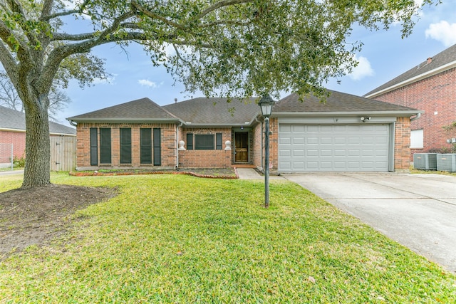 single story home with a garage, central AC unit, and a front yard