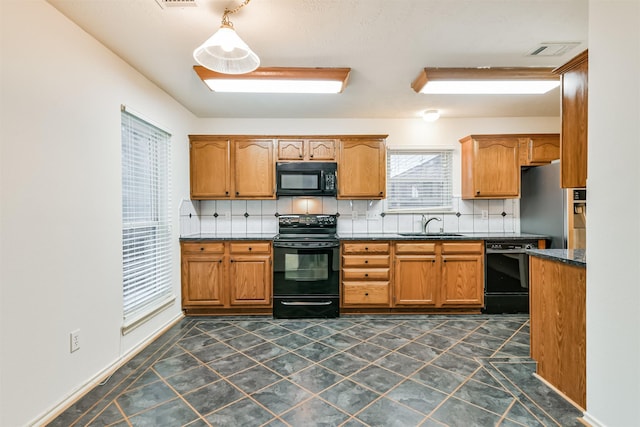 kitchen with sink, decorative backsplash, and black appliances