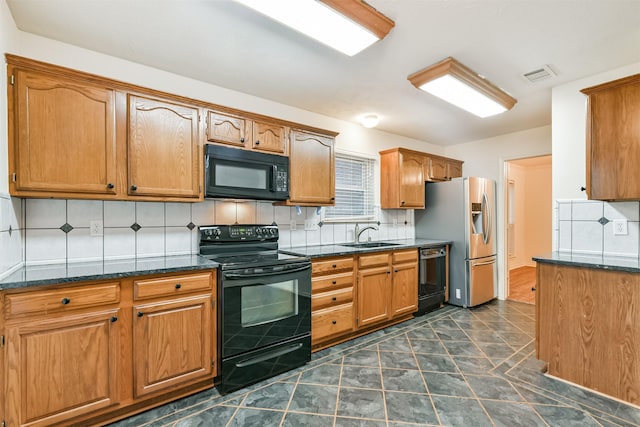 kitchen with tasteful backsplash, dark stone counters, sink, and black appliances