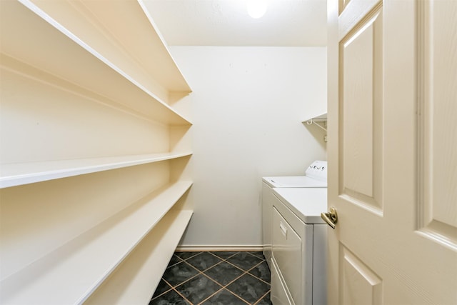 laundry room with tile patterned flooring and washer and clothes dryer