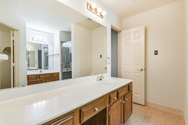 bathroom with vanity, an enclosed shower, and tile patterned floors