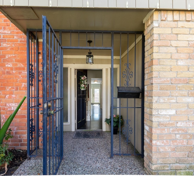 view of exterior entry featuring brick siding