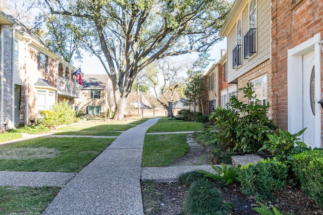 view of community featuring a lawn and a residential view