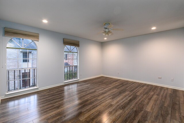 empty room with ceiling fan and dark hardwood / wood-style flooring