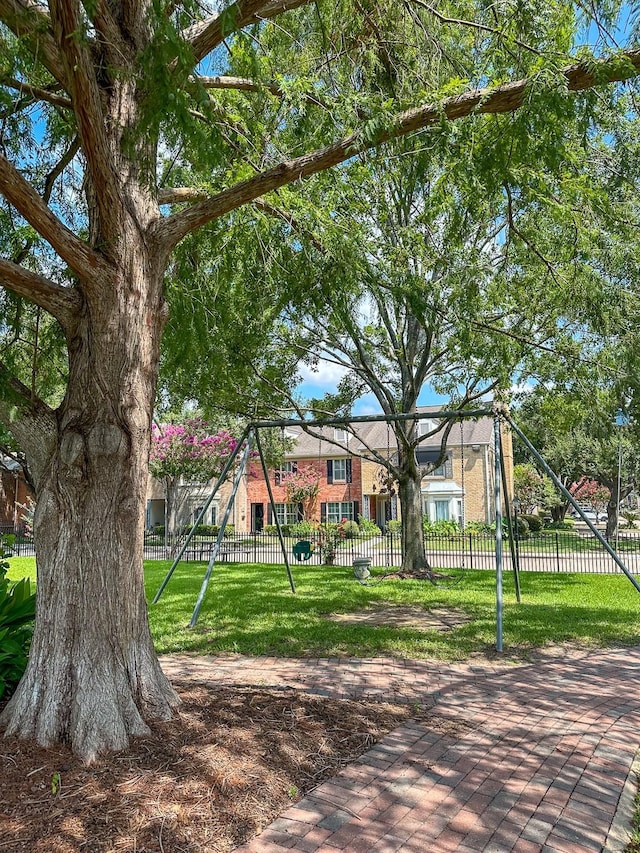 view of jungle gym featuring fence private yard and a lawn