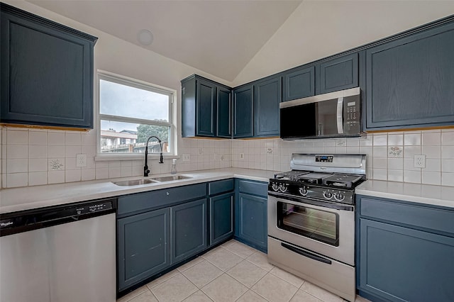 kitchen with vaulted ceiling, appliances with stainless steel finishes, blue cabinets, and sink