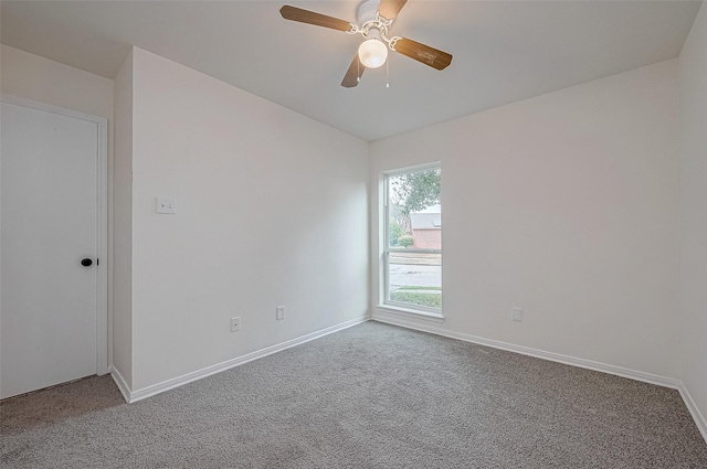 carpeted empty room featuring ceiling fan