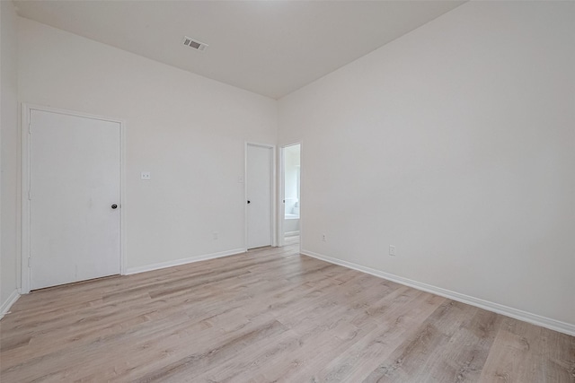 unfurnished room with light wood-type flooring