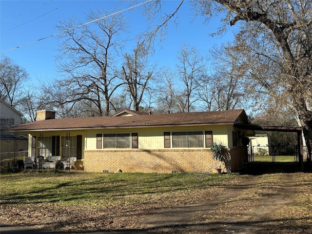 view of front of home with a front lawn and a carport